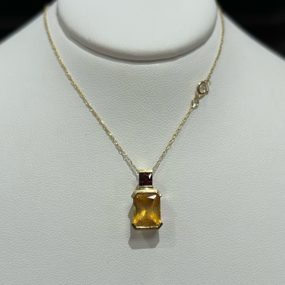 10kt yellow gold setting with cushion cut Citrine and Garnet accent stone.